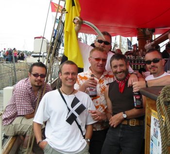 Rascally looking crew,
taken aboard a Cornish sailing-ship in Brittany, partaking
of Cornish ale